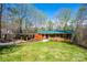 Charming single-story brick home with a green metal roof, carport, and a well-manicured lawn at 444 27Th Avenue Nw Cir, Hickory, NC 28601