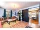 Comfortable living room with a plush leather couch, hardwood floors, and a view into dining area with black sliding door at 444 27Th Avenue Nw Cir, Hickory, NC 28601