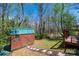 Backyard storage shed with a green roof, accessed by a stone paver pathway at 444 27Th Avenue Nw Cir, Hickory, NC 28601