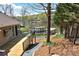Home's deck overlooks the lake, boat dock, and lush landscaping at 458 Pinehaven Dr, Badin Lake, NC 28127