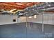 Unfinished basement with open ceiling, painted floors, and ample open space at 458 Pinehaven Dr, Badin Lake, NC 28127