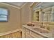 Bright bathroom with modern vanity, sink, and well-lit mirror over vinyl floors at 458 Pinehaven Dr, Badin Lake, NC 28127