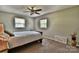 Cozy bedroom with a ceiling fan, carpeted floors, and two bright windows at 458 Pinehaven Dr, Badin Lake, NC 28127