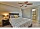 The bedroom leads into the bathroom and features neutral paint with a ceiling fan at 458 Pinehaven Dr, Badin Lake, NC 28127