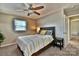 Bedroom has carpeted floors, a ceiling fan and side tables with lamps at 458 Pinehaven Dr, Badin Lake, NC 28127