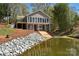 Modern lake house with a private pond, garage, and spacious entertainment deck at 458 Pinehaven Dr, Badin Lake, NC 28127