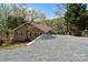 Lake house with a gravel driveway, offering convenient parking and easy access to waterfront activities at 458 Pinehaven Dr, Badin Lake, NC 28127