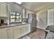 Modern kitchen featuring white cabinets, stainless steel appliances, and a bright window over the sink at 458 Pinehaven Dr, Badin Lake, NC 28127