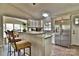 Well-lit kitchen featuring stainless steel appliances, stone countertops, and stylish bar seating at 458 Pinehaven Dr, Badin Lake, NC 28127