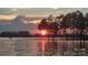 Sunset view over the lake, framed by trees at 458 Pinehaven Dr, Badin Lake, NC 28127
