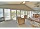 Bright living room boasts expansive windows with lake views, creating a serene and inviting atmosphere for relaxation at 458 Pinehaven Dr, Badin Lake, NC 28127