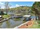 Beautiful waterfront view showcasing a private dock and boat shelter, offering direct access and scenic lake enjoyment at 458 Pinehaven Dr, Badin Lake, NC 28127