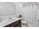 Bathroom showcasing a vanity, toilet, and shower with decorative curtain at 5104 Thomasville Dr, Belmont, NC 28012