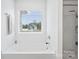 Bathroom showing a large bathtub, a window, and a separate shower with glass door at 5104 Thomasville Dr, Belmont, NC 28012