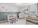 Charming Bedroom with floral accents, a white crib, comfortable armchair, and a delightful raccoon rug at 5104 Thomasville Dr, Belmont, NC 28012