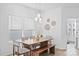 Bright dining room featuring a wood table, modern pendant lighting, and minimalist decor at 5104 Thomasville Dr, Belmont, NC 28012