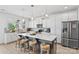 Spacious kitchen with white cabinets, stainless steel appliances, gray backsplash, and seating at the center island at 5104 Thomasville Dr, Belmont, NC 28012