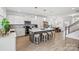 Bright, open kitchen features an island with stool seating, stainless appliances, and stylish pendant lighting at 5104 Thomasville Dr, Belmont, NC 28012