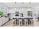 Bright kitchen offers seating at the island with white countertop, light wood floors and stainless steel refrigerator at 5104 Thomasville Dr, Belmont, NC 28012