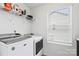 Functional laundry room with modern appliances, shelving, and a window at 5104 Thomasville Dr, Belmont, NC 28012