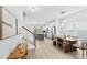 Open-concept living space with a modern kitchen, staircase, and dining area, filled with natural light at 5104 Thomasville Dr, Belmont, NC 28012