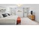 This bedroom features a large bed, wooden nightstand, and plenty of natural light from the two windows at 5104 Thomasville Dr, Belmont, NC 28012