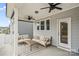 Covered patio with neutral seating, ceiling fans, and an outdoor living space at 5104 Thomasville Dr, Belmont, NC 28012