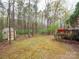 Backyard featuring a shed, a wooded area, and a deck area with a grill at 6108 Mcilwaine Rd, Huntersville, NC 28078