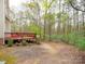 View of backyard with a wooden deck and wooded scenery providing a natural outdoor space at 6108 Mcilwaine Rd, Huntersville, NC 28078