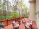 Cozy deck seating area with chairs, a table, and serene wooded views at 6108 Mcilwaine Rd, Huntersville, NC 28078