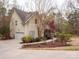 Side view of a two-story home with a garage, a well-manicured lawn, and colorful landscaping at 6108 Mcilwaine Rd, Huntersville, NC 28078