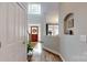 Welcoming foyer with hardwood floors, a staircase, decorative niche, and a view of the front door at 6108 Mcilwaine Rd, Huntersville, NC 28078