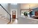 Lovely foyer with hardwood floors, staircase, dining area view, and a decorative front door at 6108 Mcilwaine Rd, Huntersville, NC 28078