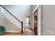 Open foyer with hardwood floors, staircase, a decorative front door, and office in view at 6108 Mcilwaine Rd, Huntersville, NC 28078