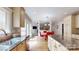 Bright kitchen features granite counters, stainless steel sink, and view to dining area at 6108 Mcilwaine Rd, Huntersville, NC 28078
