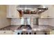 Close up of professional-grade stainless steel range and vent hood with tile backsplash at 6108 Mcilwaine Rd, Huntersville, NC 28078