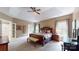 Main bedroom has a trey ceiling, neutral walls, lots of light, and an ensuite bath creating a private retreat at 6108 Mcilwaine Rd, Huntersville, NC 28078