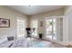Bright office space with a desk, large windows, and a cozy rug at 6108 Mcilwaine Rd, Huntersville, NC 28078