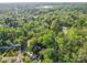 Aerial view of a neighborhood with lush trees, winding roads, and residential homes at 615 Ridgeway Dr, Belmont, NC 28012
