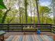Cozy back deck with a decorative outdoor rug overlooking a tranquil view of the backyard at 615 Ridgeway Dr, Belmont, NC 28012