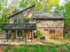 Two-story home featuring a large deck, a lower patio, and a combination of siding and brick exterior at 615 Ridgeway Dr, Belmont, NC 28012
