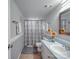 Clean bathroom with a shower, grey walls, a light blue countertop, and decorative sunflowers at 615 Ridgeway Dr, Belmont, NC 28012
