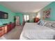 Bright bedroom with wooden dressers, a queen bed with white linens, and mint colored walls at 615 Ridgeway Dr, Belmont, NC 28012