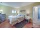 Cozy bedroom with warm lighting, parquet floors, neutral decor and ensuite bathroom at 615 Ridgeway Dr, Belmont, NC 28012