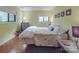 Serene bedroom with sunny yellow walls, featuring two large windows and simple decor at 615 Ridgeway Dr, Belmont, NC 28012