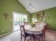 Bright dining room, featuring large window and a table for four, connected to an outdoor deck at 615 Ridgeway Dr, Belmont, NC 28012