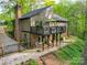 A rear exterior view of the home with a second-story deck and a spacious outdoor area at 615 Ridgeway Dr, Belmont, NC 28012
