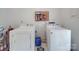 Functional laundry room featuring a washer, dryer, and water filtration system at 615 Ridgeway Dr, Belmont, NC 28012