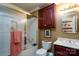 Traditional bathroom with tiled shower, cherry cabinets, and modern fixtures at 6307 Roanoke Dr # 17, Kannapolis, NC 28081
