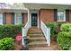Close-up of brick home entrance with stairs and manicured landscaping at 6307 Roanoke Dr # 17, Kannapolis, NC 28081